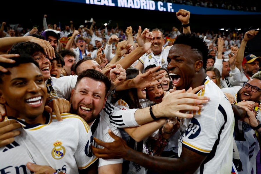 Real Madrid's Vinicius Junior and Rodrygo celebrate with fans after Jude Bellingham scores their third goal. - REUTERS PIC