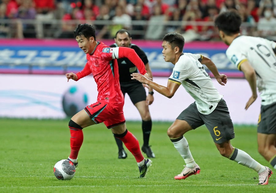 South Korea's Son Heung-min in action with China's Wang Shangyuan. - REUTERS PIC