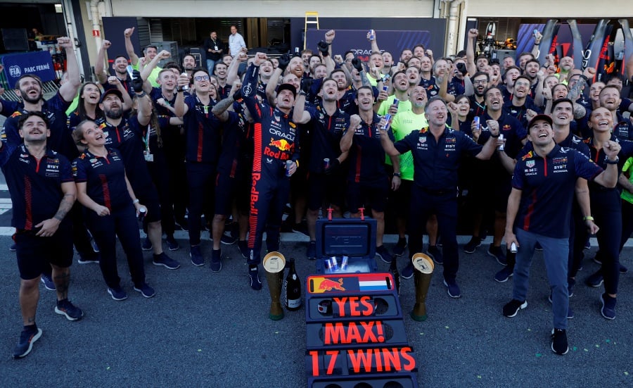 Red Bull's Max Verstappen poses for a picture after winning the Brazilian Grand Prix with Red Bull's Sergio Perez, Red Bull team principal Christian Horner and teammates. - REUTERS Pic