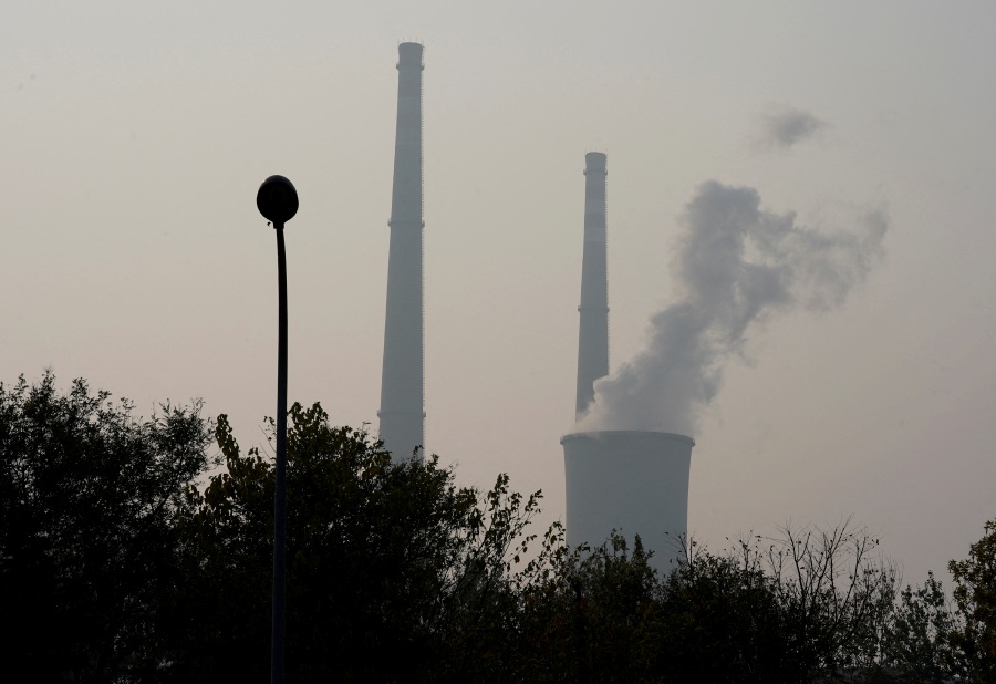 FILE PHOTO: A cooling tower and chimneys are seen at a thermal power plant on a polluted day in Beijing, China, November 3, 2018. - REUTERS pic