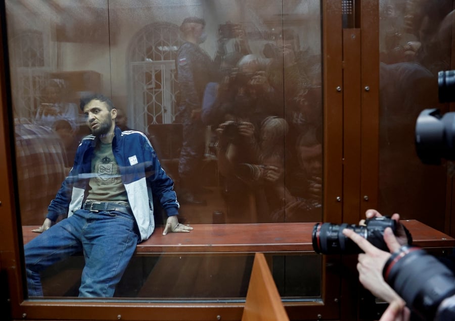 Dalerdzhon Mirzoyev, a suspect in the shooting attack at the Crocus City Hall concert venue, sits behind a glass wall of an enclosure for defendants at the Basmanny district court in Moscow. Reuters Pic