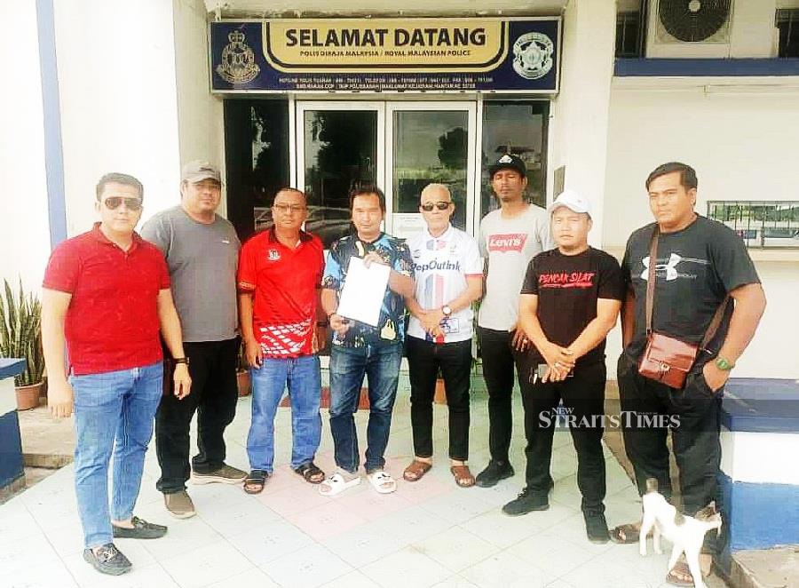 Sabah Chief Minister's Son, Mohd Reza Hajiji (4th from the left) filing a police report at the Tuaran District Police Headquarters this afternoon. - NSTP/JOHARY INDAN