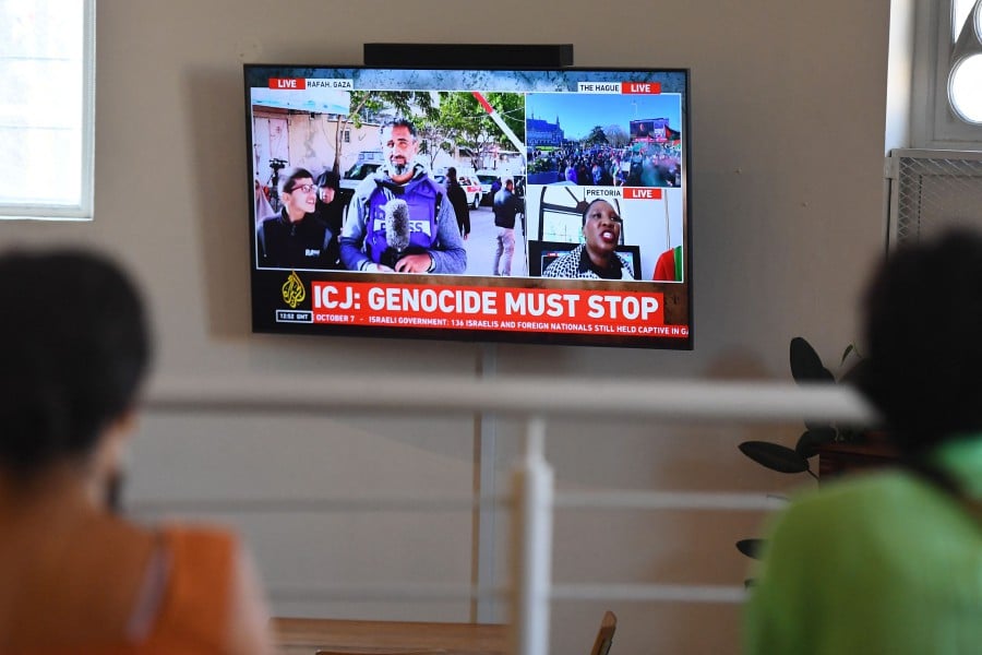 People gather to watch the International Court of Justice (ICJ) ruling of the case against Israel brought by South Africa in The Hague at the Bertha House in Cape Town on January 26, 2024. AFP PIC