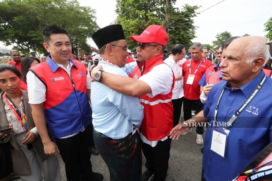 PKR secretary-general Datuk Seri Saifuddin Nasution (second from right) embracing Sungai Bakap by-election Pakatan Harapan’s candidate Dr Joohari Ariffin (second from left). - NSTP/MIKAIL ONG