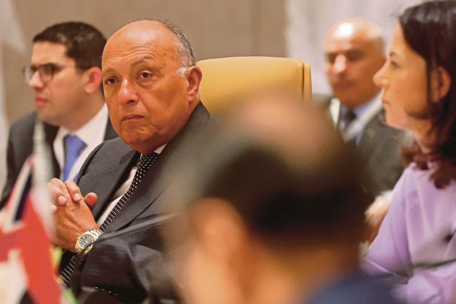 German Foreign Minister Annalena Baerbock (right) and Egypt's Foreign Minister Sameh Shoukry (left) attend a ministerial meeting held in Riyadh to discuss the Gaza crisis amid the ongoing conflict in the Palestinian territory between Israel and Hamas. (Photo by Fayez Nureldine / AFP)