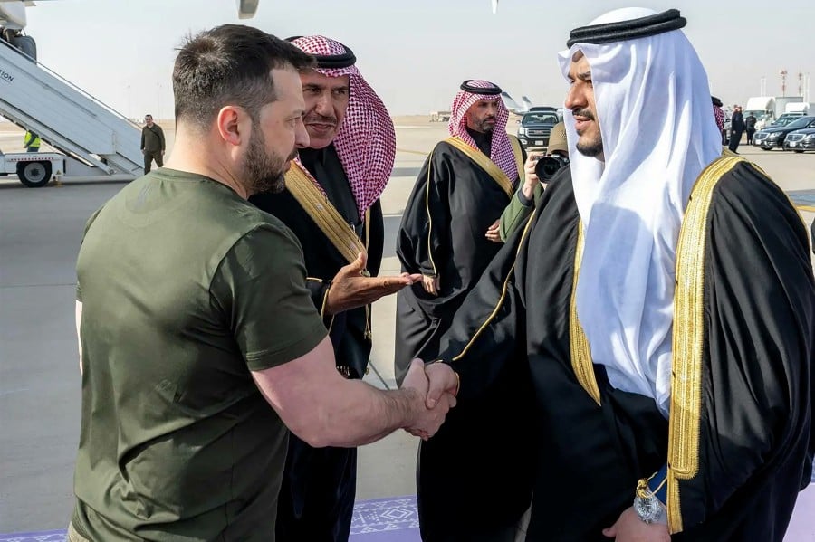 A handout picture released by the official Saudi Press Agency (SPA) shows the Deputy Governor of Riyadh, Prince Mohammed bin Abdul Rahman bin Abdulaziz, welcoming Ukraine's President Volodymyr Zelensky at the Saudi capital's King Khalid International Airport on February 27, 2024. The Ukrainian leader is on an official visit to Saudi Arabia for talks on exchange of Prisoners of War (POW) with Russia. - (Photo by SAUDI PRESS AGENCY / AFP) 