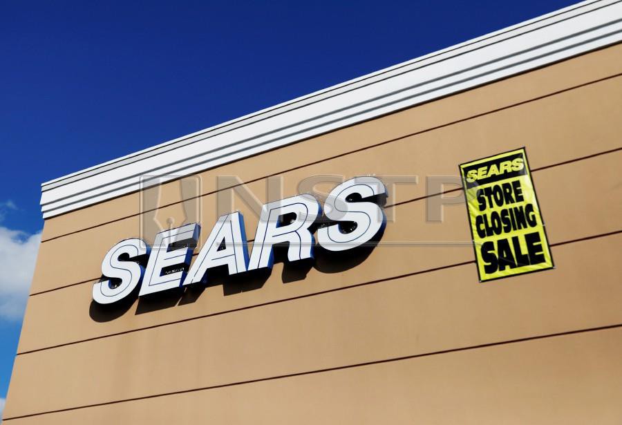 FILE PHOTO: A store closing sale sign is posted next to a Sears logo in New Hyde Park, New York, U.S., October 10, 2018. Photo by Reuters.