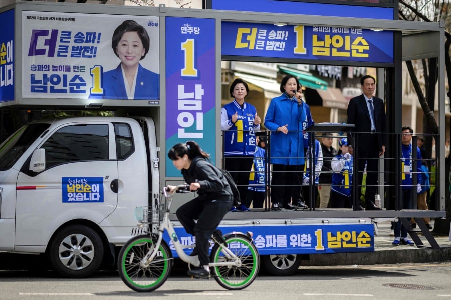 Party lawmaker Nam In-soon (centre) attends a campaign event as she runs for her fourth term in office in Seoul's outer Songpa district, ahead of the upcoming parliamentary elections. (Photo by ANTHONY WALLACE / AFP)