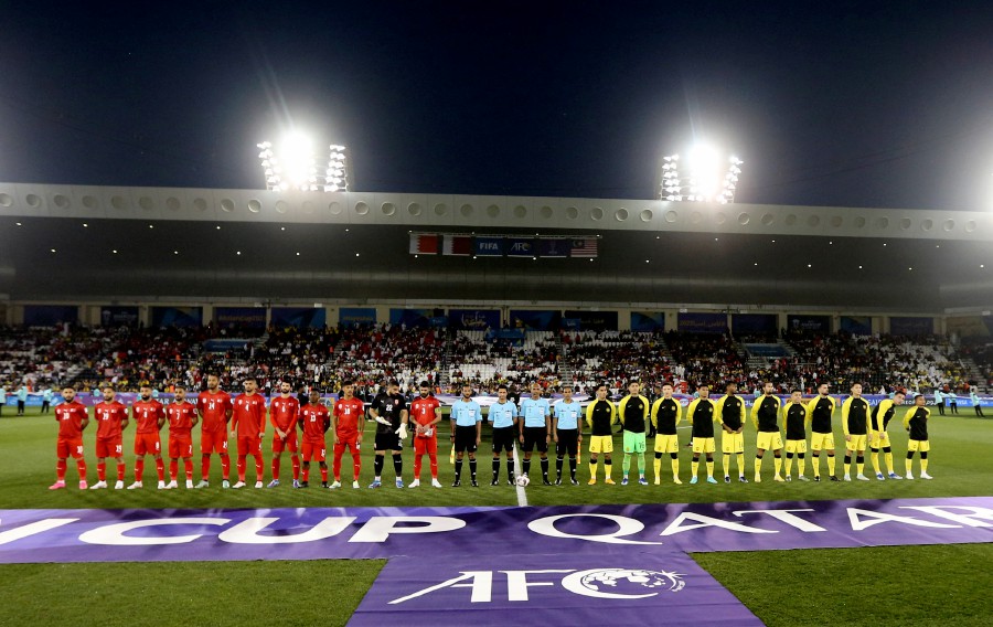 Bahrain and Malaysia players line up with the match officials before the match. REUTERS PIC