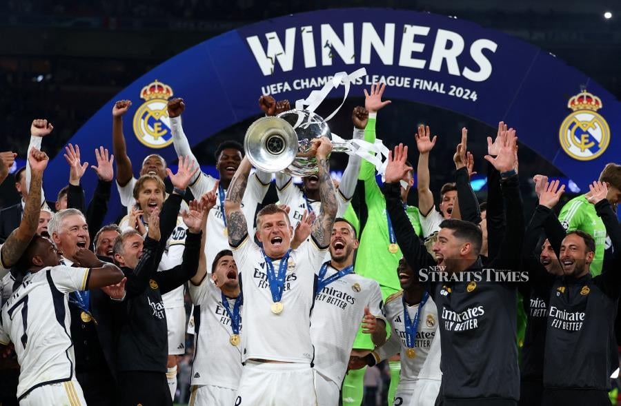 Real Madrid's Toni Kroos celebrates with the trophy after winning the Champions League. - REUTERS/Hannah Mckay