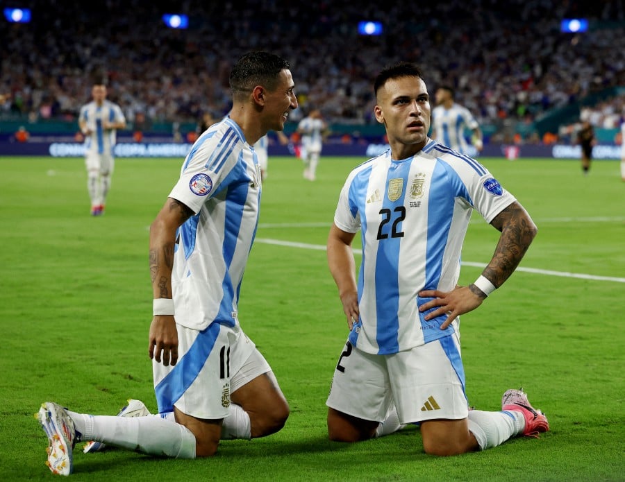 Argentina's Lautaro Martinez celebrates scoring their first goal with Argentina's Angel Di Maria. REUTERS PIC