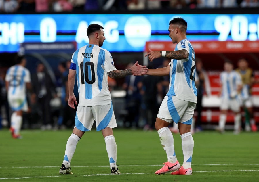 Argentina's Lautaro Martinez celebrates after the match with Argentina's Lionel Messi. REUTERS PIC