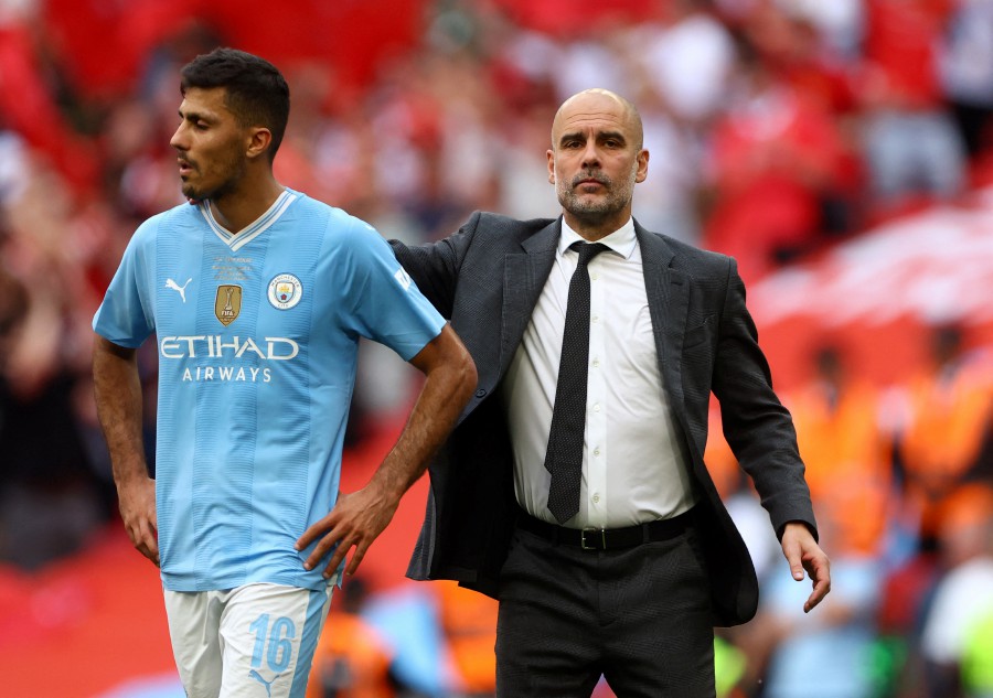 Manchester City manager Pep Guardiola and Rodri look dejected after the match. REUTERS PIC