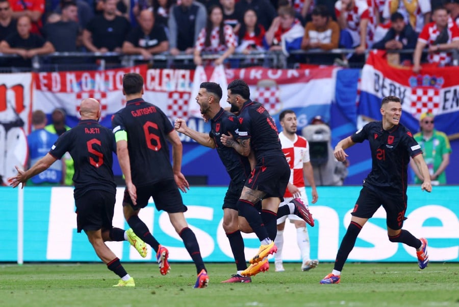 Albania's Klaus Gjasula celebrates scoring their second goal with teammates. REUTERS PIC