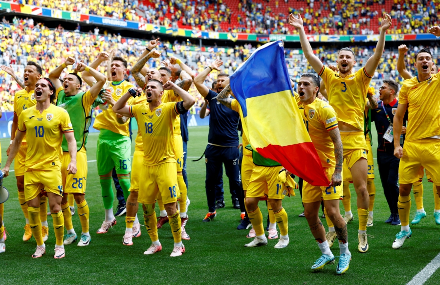 Romania's Razvan Marin, Nicolae Stanciu and teammates celebrate after the match. (REUTERS/Michaela Stache)