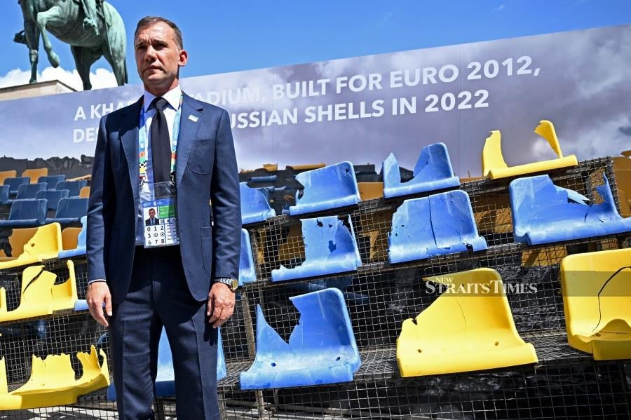 Ukrainian Association of Football president Andriy Shevchenko presents seats at Wittelsbacherplatz, from the Sonyachny Stadium in Kharkiv that were shelled by Russian missiles ahead of the Euro 2024 match between Ukraine and Romania on Monday. REUTERS PICS