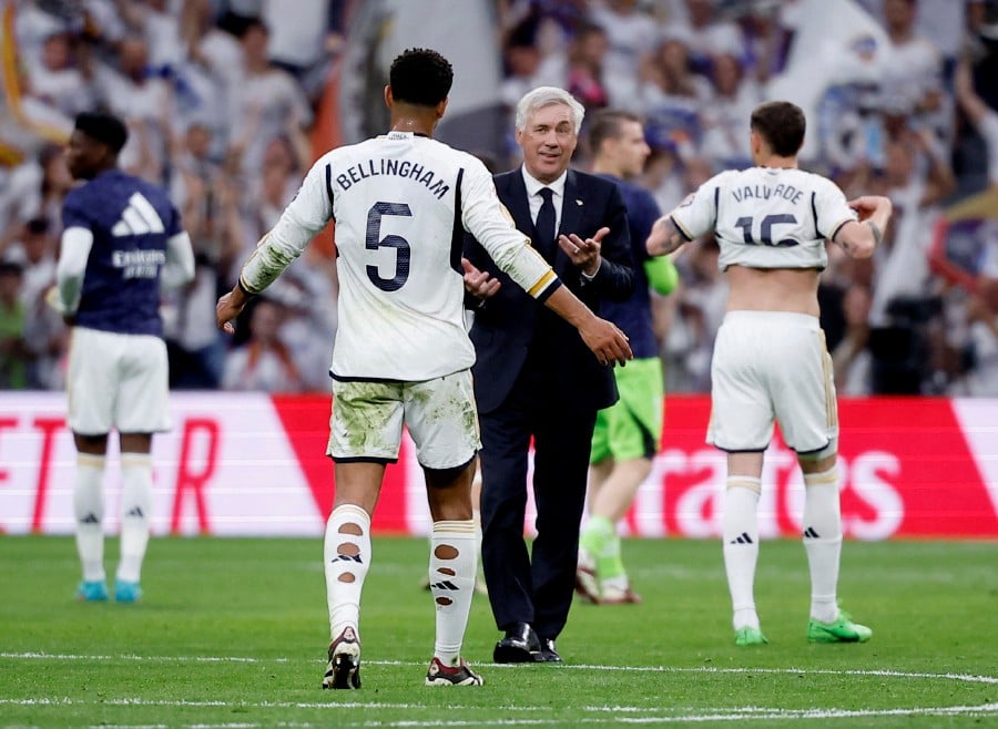 Real Madrid coach Carlo Ancelotti and Jude Bellingham celebrate after the match. REUTERS PIC
