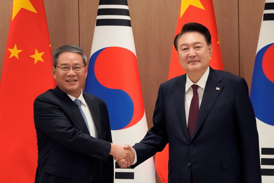 South Korean President Yoon Suk Yeol, right, shakes hands with Chinese Premier Li Qiang during a meeting at the Presidential Office in Seoul, South Korea, Sunday, May 26, 2024. REUTERS PIC