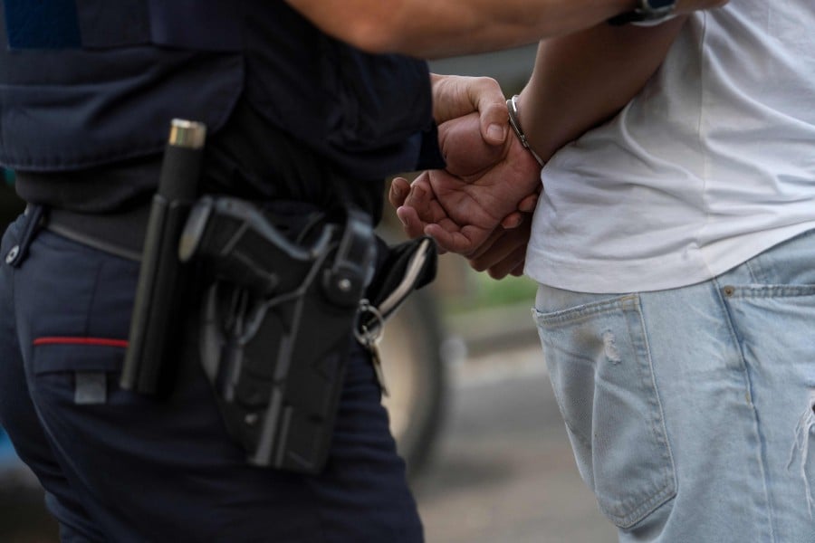 Catalan regional police forces Mossos d'Esquadra officers detain a suspect during a pre-dawn raid on several homes in southern Catalonia this month. AFP