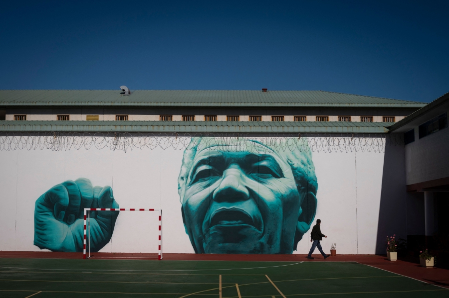 A mural depicting former South Africa President Nelson Mandela covers a wall of the yard of the Teixeiro prison, near A Coruna. (Photo by MIGUEL RIOPA / AFP)