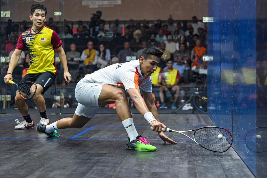 India's Abhay Singh (R) hits a shot against Ong Sai Hung during their semifinal match at the SDAT WSF Squash World Cup 2023 in Chennai on June 16, 2023. -AFP PIC