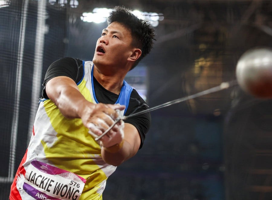 Jackie was not sure what exactly went wrong. He was desperate for a good mark but two of his throws at the Hangzhou Olympic Stadium were disallowed. PIC COURTESY HAGOC