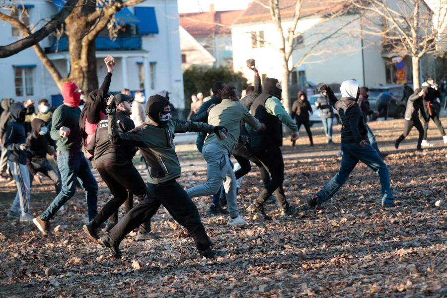 Counter-protesters throw stones in the park Sveaparken in Orebro, south-centre Sweden on April 15, 2022, where Danish far-right party Stram Kurs had permission for a square meeting on Good Friday. (Photo by Kicki NILSSON / TT NEWS AGENCY / AFP)