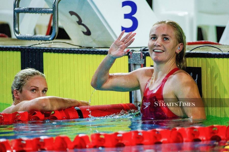 Australia’s Ariarne Titmus (right) reacts after finishing first in the women’s 400m freestyle final during the Australian Swimming Trials at the Brisbane Aquatic Centre today. AFP PIC 