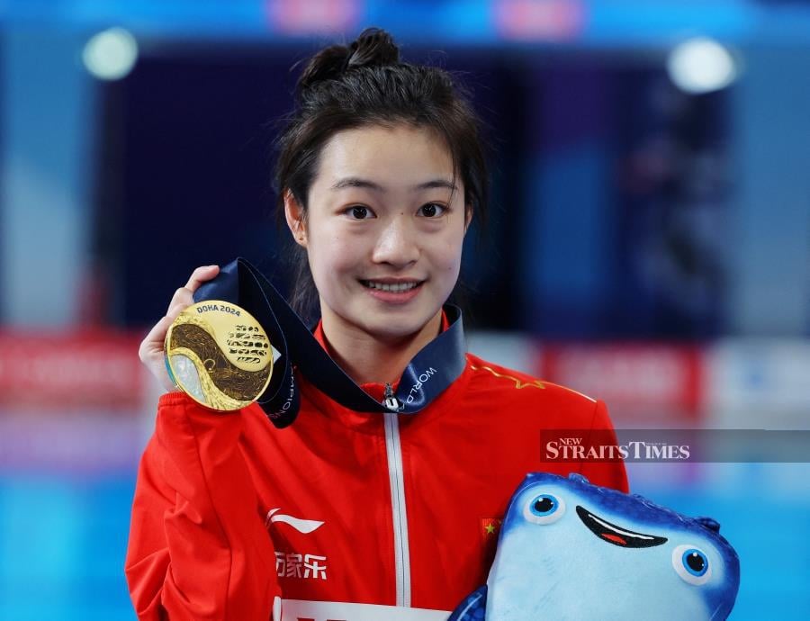 Gold medallist Chang Yani poses with her medal after winning the women’s 3m springboard final at the World Aquatics Championships in Doha, Qatar, on Friday. REUTERS PIC