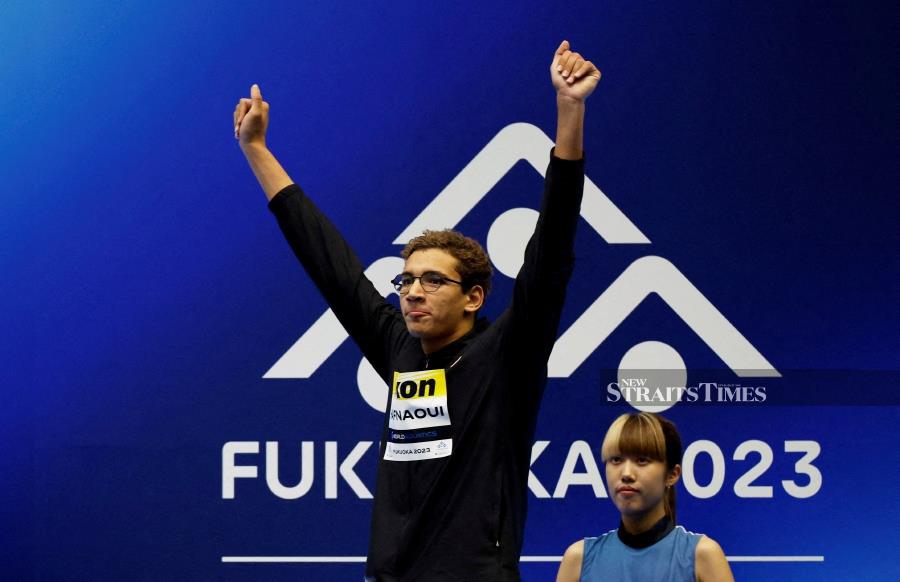 Tunisia's Ahmed Hafnaoui celebrates on the podium after winning the men's 1,500m freestyle final at the World Aquatics Championships in Fukuoka, Japan on July 30, 2023. REUTERS PIC
