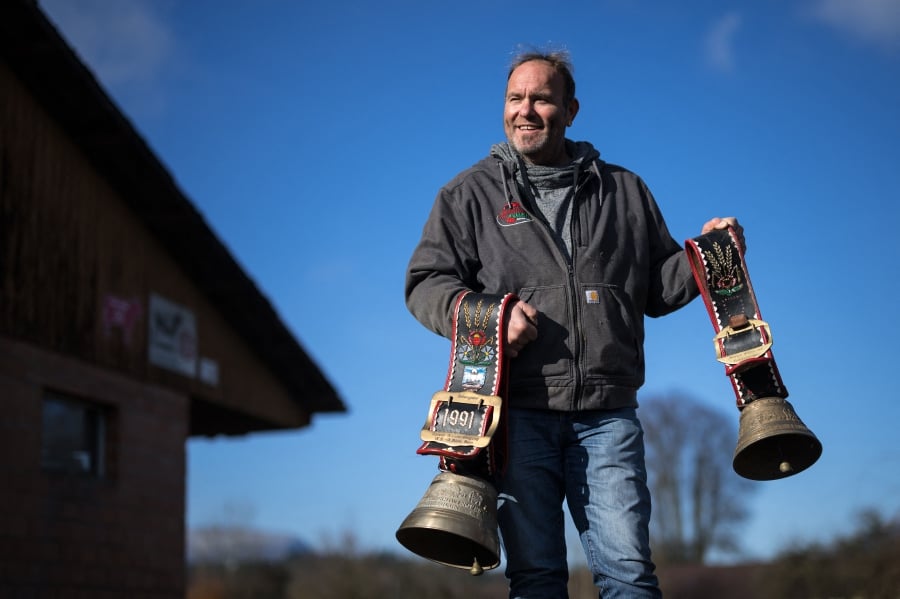 Farmer Rolf Rohrbach poses with cow bells used during transhumance in the village of Aarwangen, central Switzerland. (Photo by Fabrice COFFRINI / AFP)