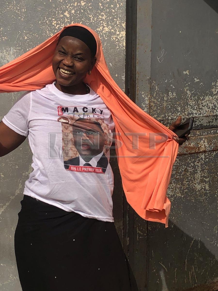 A Macky Sall supporter wearing a t-shirt bearing a photo of him. Pix courtesy of writer 