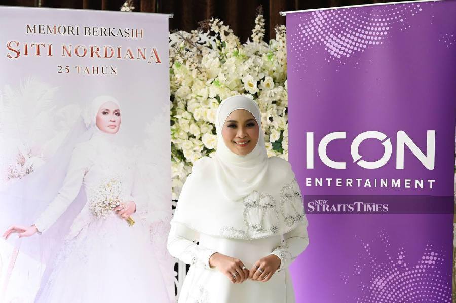 Popular singer and actress Siti Nordiana Alias is not about to tie the knot, despite her social media page’s week-long gimmick showing photos of her dressed in white and holding a bouquet of flowers. - NSTP/NUR RAIHANA ALIA