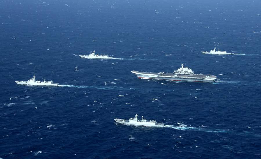 (FILES) This aerial file  shows a Chinese Navy formation, including the aircraft carrier Liaoning (C), during military drills in the South China Sea. -  (Photo by STR / AFP) 