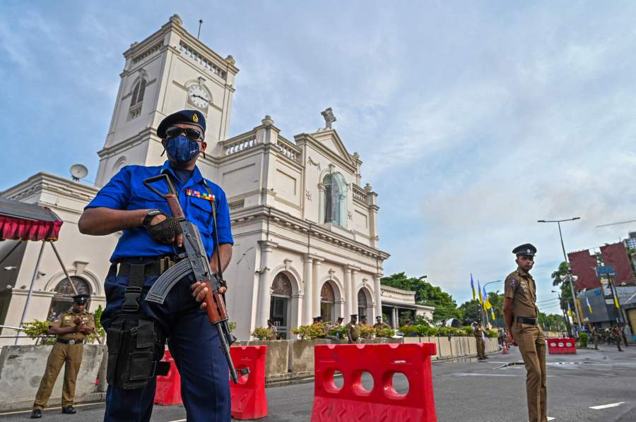 A navy sailor and police officers stand guard outside St. Anthony's church on the fifth anniversary of the Easter Sunday suicide attacks, in Colombo on April 21, 2024. The United Nations on April 21 urged Sri Lanka to bridge its "accountability deficit" and ensure justice as the country commemorated the 279 victims of the worst violence against civilians. - AFP pic