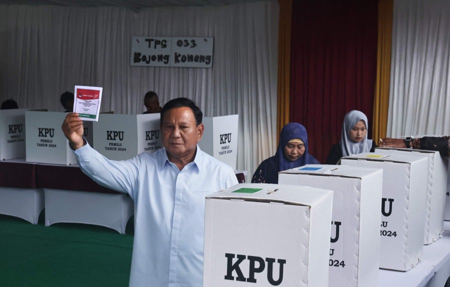 Indonesia's presidential candidate Prabowo Subianto holds his ballot to vote in Indonesia’s presidential and legislative elections at a polling station in Bogor, West Java. - AFP PIC