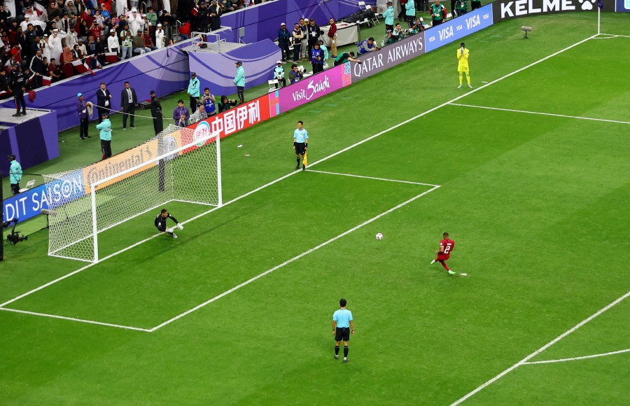 Qatar's Pedro Miguel scores the winning penalty during a penalty shootout. -- REUTERS