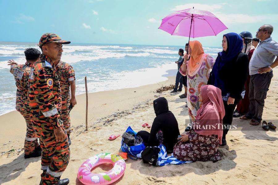 A 44-year-old woman could only witness in anguish as her husband was swept out to sea at Pantai Batu Burok earlier, today. - NSTP/GHAZALI KORI