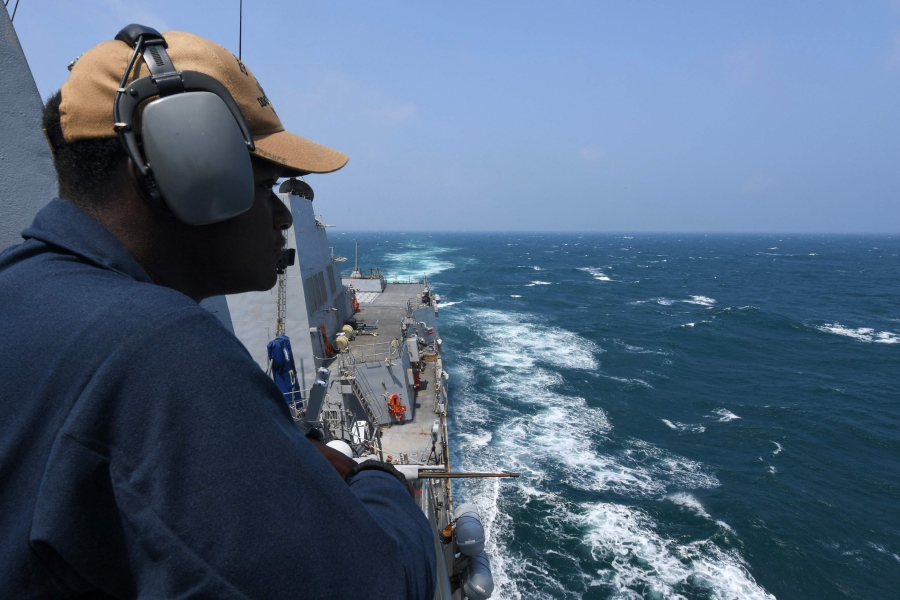 Seaman Gary Beckles, from Laurel, Maryland, standing port lookout aboard the Arleigh Burke-class guided-missile destroyer USS Halsey (DDG 97) during routine underway operations while transiting through the Taiwan Strait. (Photo by Ismael Martinez / US NAVY / AFP) 