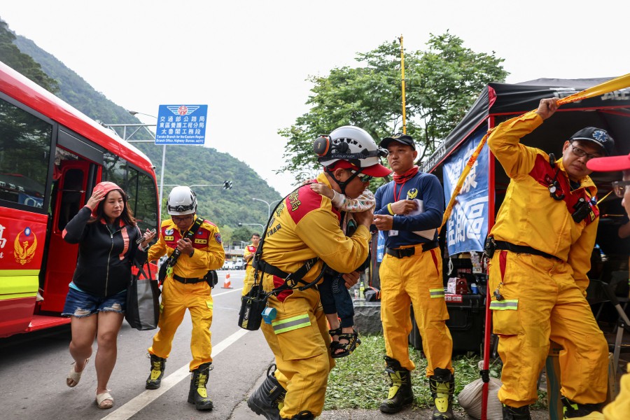 A woman gets out of a van at a temporary rescue command post after being rescued from the Taroko National Park in Hualien on April 5, 2024 following the April 3 earthquake. Ten people were killed and nearly 1,100 injured in the April 3 magnitude-7.4 quake, but strict building regulations and widespread public disaster awareness appear to have staved off a major catastrophe on the island. AFP PIC