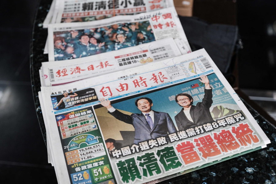Local newspapers with the ruling Democratic Progressive Party's (DPP) victory in the presidential election on the front pages remain on the counter at the reception of an office building in Taipei. (Photo by Yasuyoshi CHIBA / AFP)