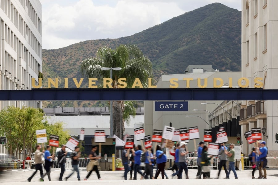 (FILE PHOTO) Workers and supporters of the Writers Guild of America protest outside Universal Studios Hollywood after union negotiators called a strike for film and television writers, in the Universal City area of Los Angeles, California, U.S., (REUTERS/Mario Anzuoni/File Photo)