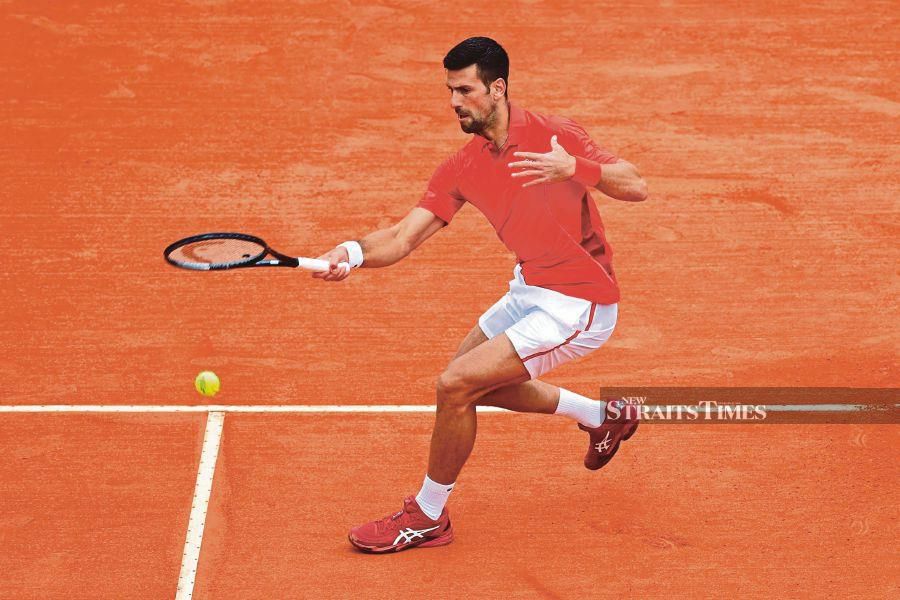 Serbia's Novak Djokovic plays a forehand return to Russia's Roman Safiullin during their Monte Carlo Masters round of 32 match on the Rainier III court at the Monte Carlo Country Club on Tuesday. AFP PIC 