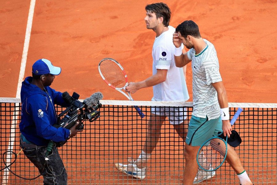 A cameraman films Russia's Karen Khachanov (R) and Britain's Cameron Norrie (C) at the end of their Monte Carlo ATP Masters Series Tournament round of 64 tennis match on the Rainier III court at the Monte Carlo Country Club on April 8, 2024. AFP PIC