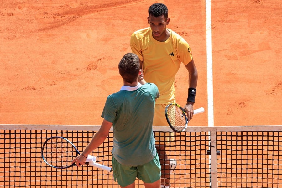 Canada's Felix Auger-Aliassime (Top) shakes hands with Italy's Luca Nardi after winning their Monte Carlo ATP Masters Series Tournament round of 64 tennis match on the Rainier III court at the Monte Carlo Country Club on April 8, 2024. AFP PIC