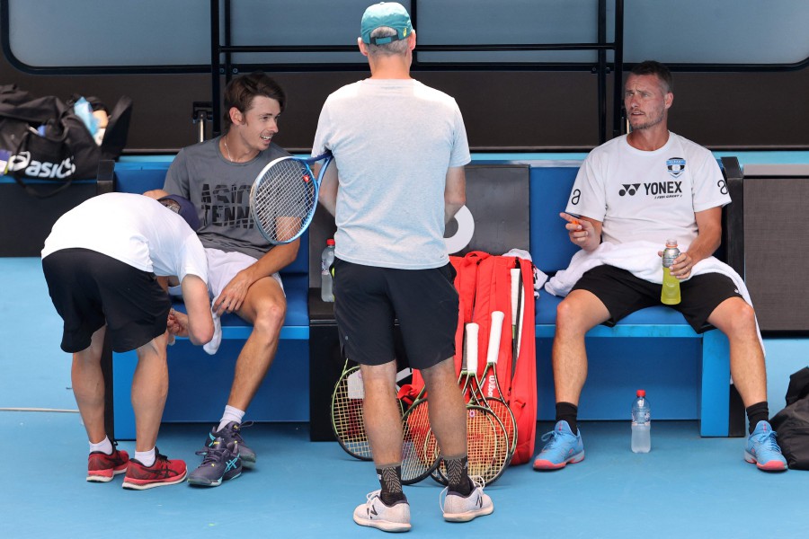 Alex de Minaur of Australia (left) and former tennis player Lleyton Hewitt attend a practice session ahead of the Australian Open tennis tournament in Melbourne on January 14, 2022. - AFP pic