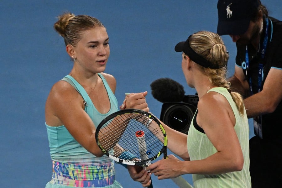 Russia's Maria Timofeeva (L) greets Denmark's Caroline Wozniacki after winning their women's singles match on day four of the Australian Open tennis tournament in Melbourne on January 17, 2024. AFP PIC