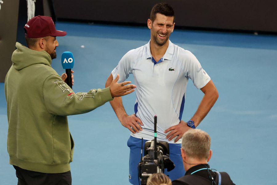 This picture taken on January 23, 2024, shows Australia tennis player Nick Kyrgios (L) taking interview of Serbia's Novak Djokovic after his men's singles quarter-final match against USA's Taylor Fritz.(Photo by David GRAY / AFP)