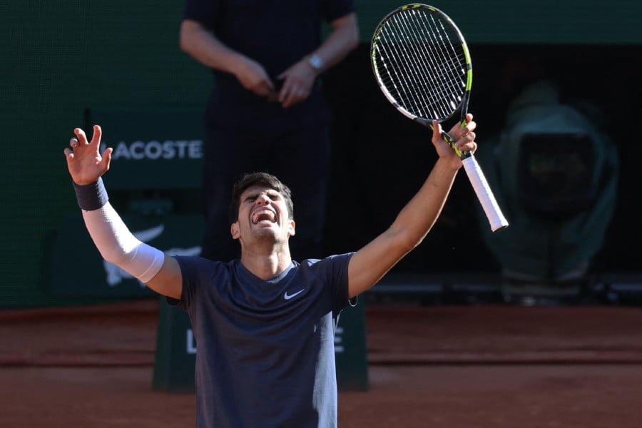 Spain's Carlos Alcaraz celebrates after winning against Italy's Jannik Sinner at the end of their men's singles semi final match on Court Philippe-Chatrier on day thirteen of the French Open tennis tournament at the Roland Garros Complex in Paris on June 7, 2024. AFP PIC