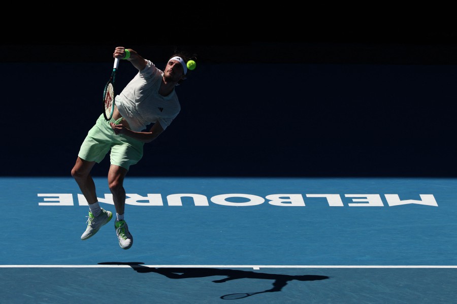 Greece's Stefanos Tsitsipas serves against Belgium's Zizou Bergs during their men's singles match on day two of the Australian Open tennis tournament in Melbourne. - AFP pic